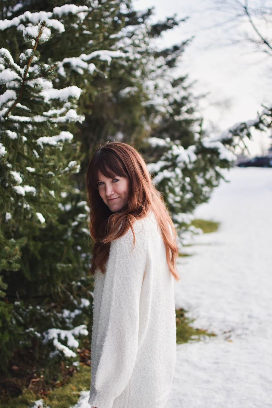 Kelsey Marshall among snow-covered evergreen trees